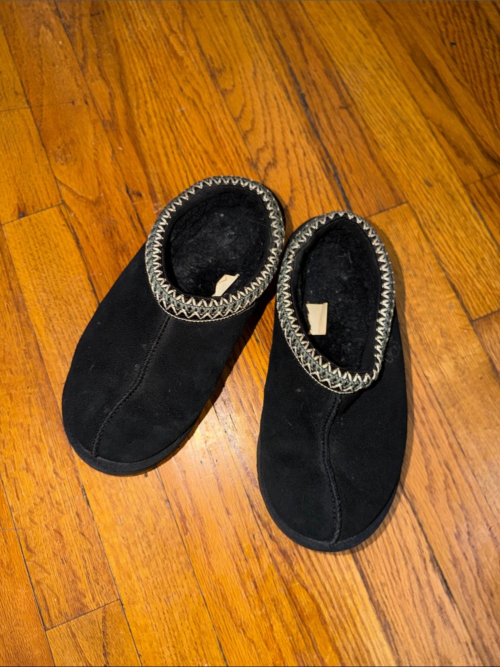 UGG Kids Black Slip-On Moccasin Slippers with Braided Trim